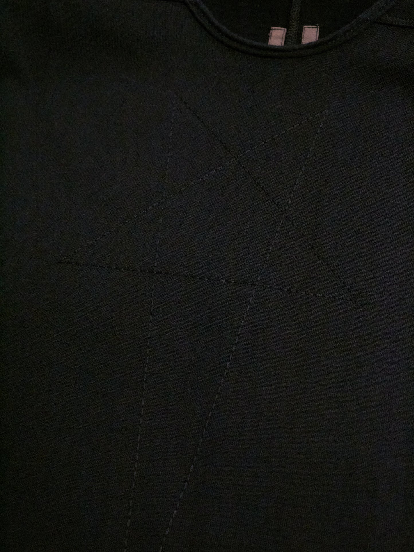 Close-up of a black fabric texture with stitching details