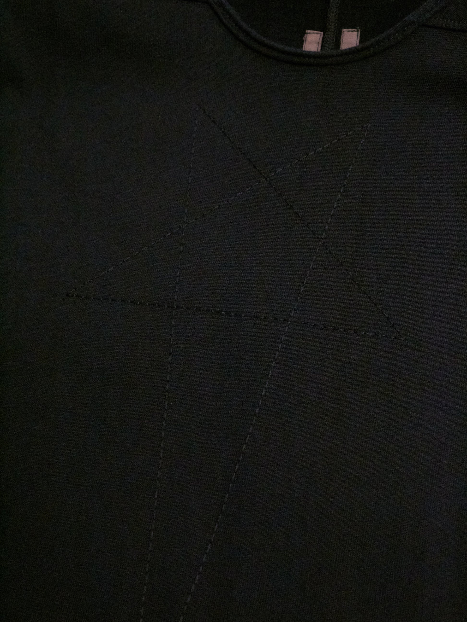 Close-up of a black fabric texture with stitching details
