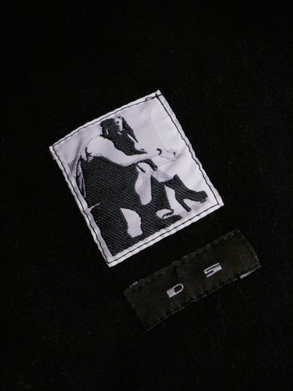 Black and white patch with graphic design on a black background