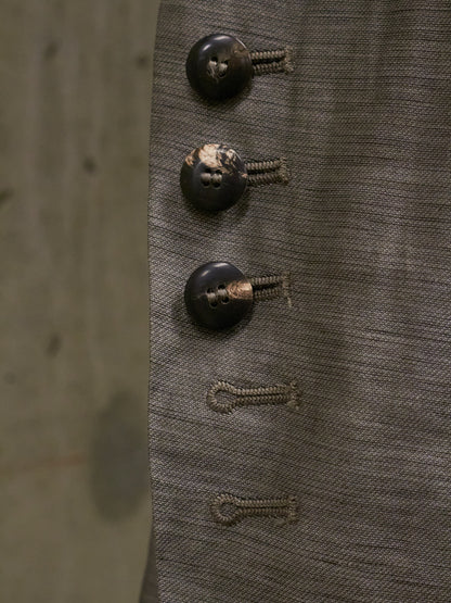 Close-up of three vintage buttons on a textured fabric background
