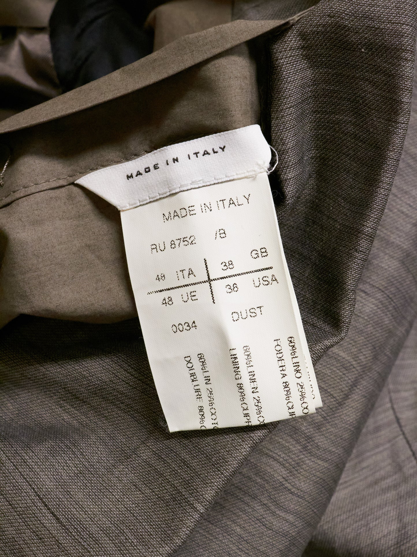 Clothing tag on a suit with 'Made in Italy' text