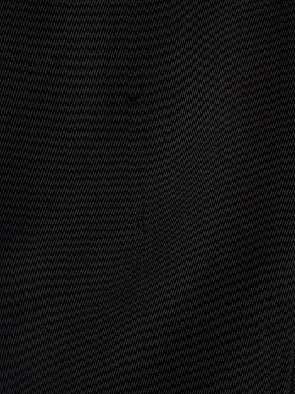 A close-up of a black textured fabric with a fine diagonal twill weave pattern.
