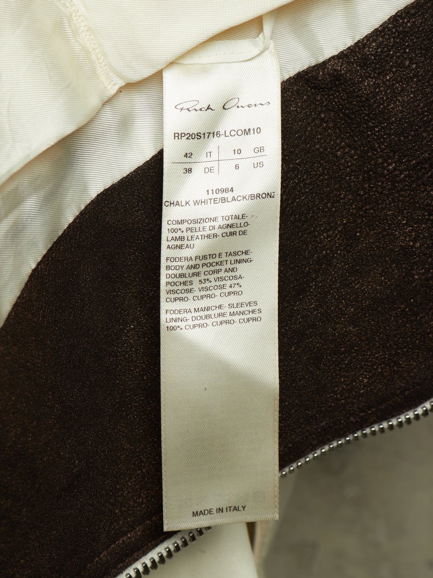 Close-up of a garment interior label reading Frank Cowen, showing the product construction details and material composition.