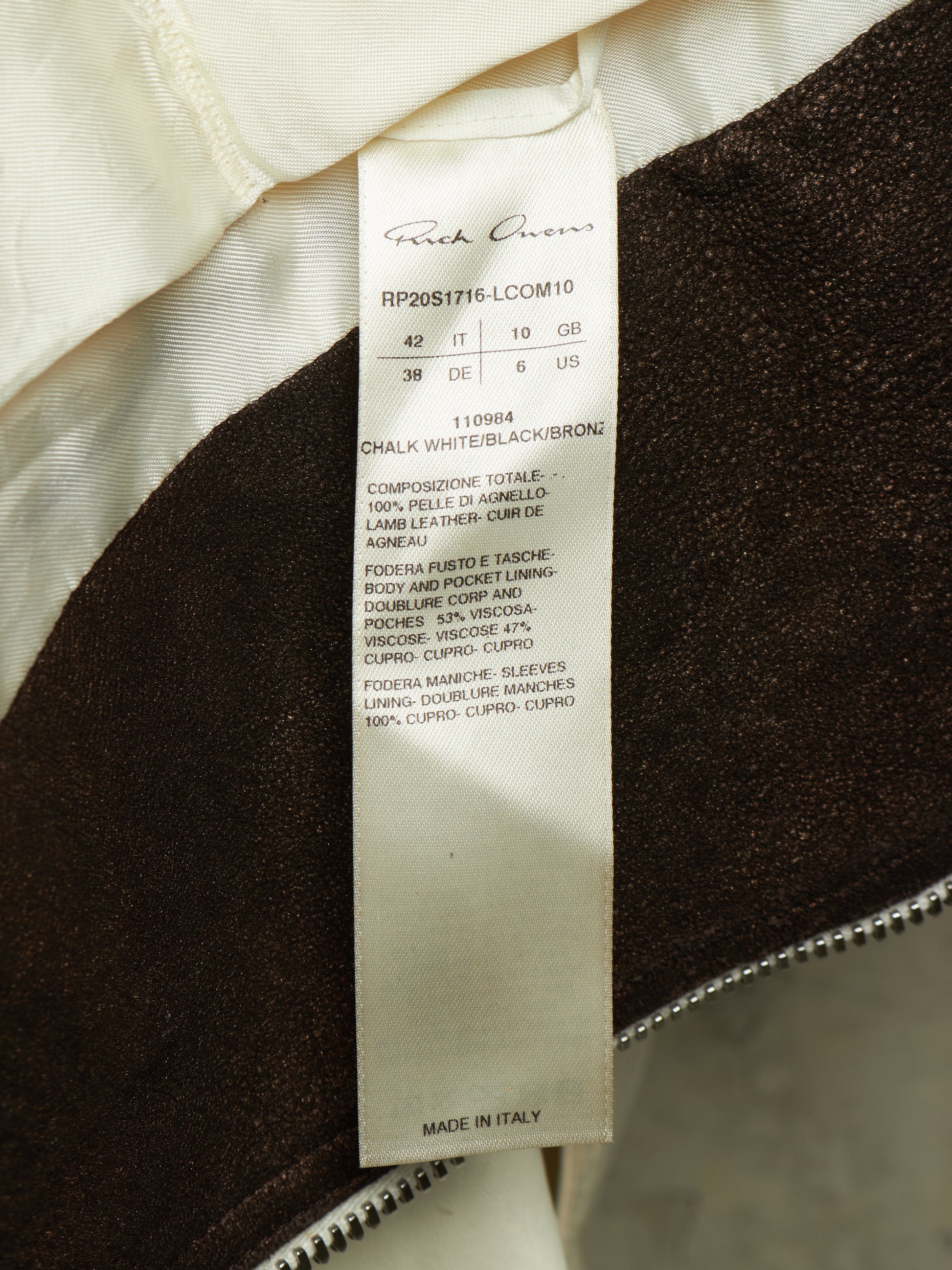 Close-up of a garment interior label reading Frank Cowen, showing the product construction details and material composition.