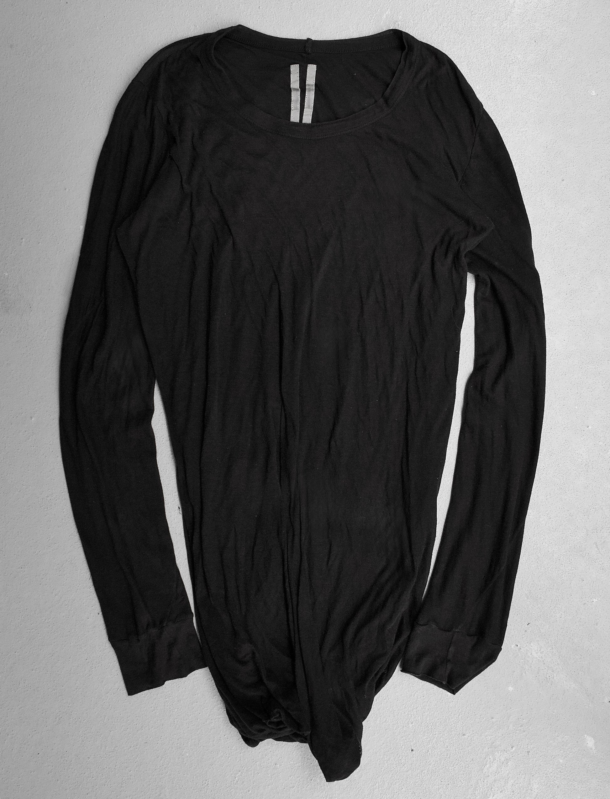 Black long-sleeve bodysuit on a gray background