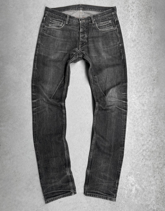 Pair of dark gray jeans on a light gray background