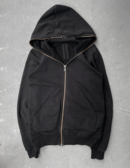 Black hoodie with a zipper on a gray textured background