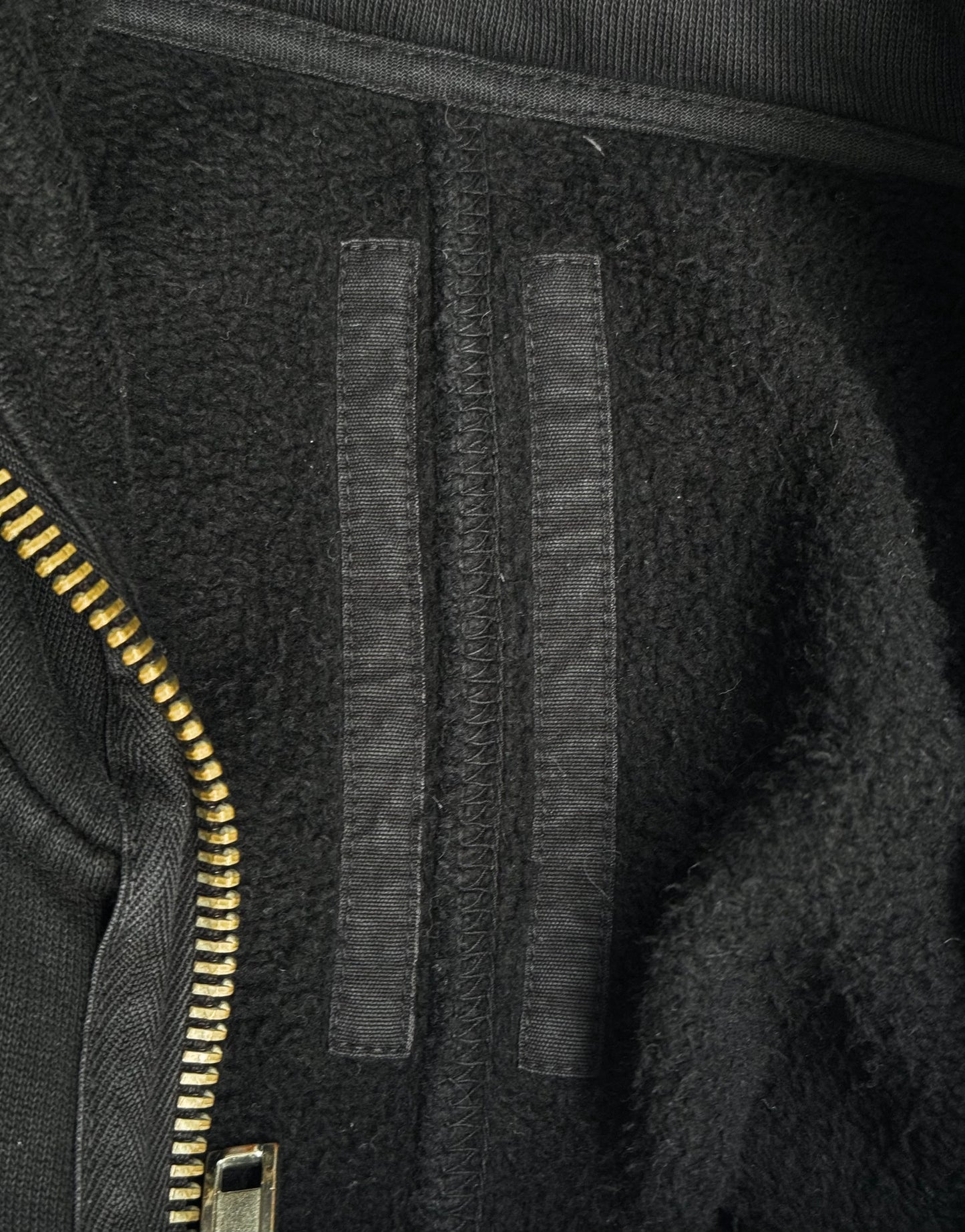 Close-up of a black jacket with a zipper and textured fabric