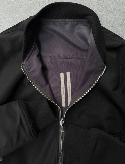 Close-up of a black jacket with a zipper on a gray background