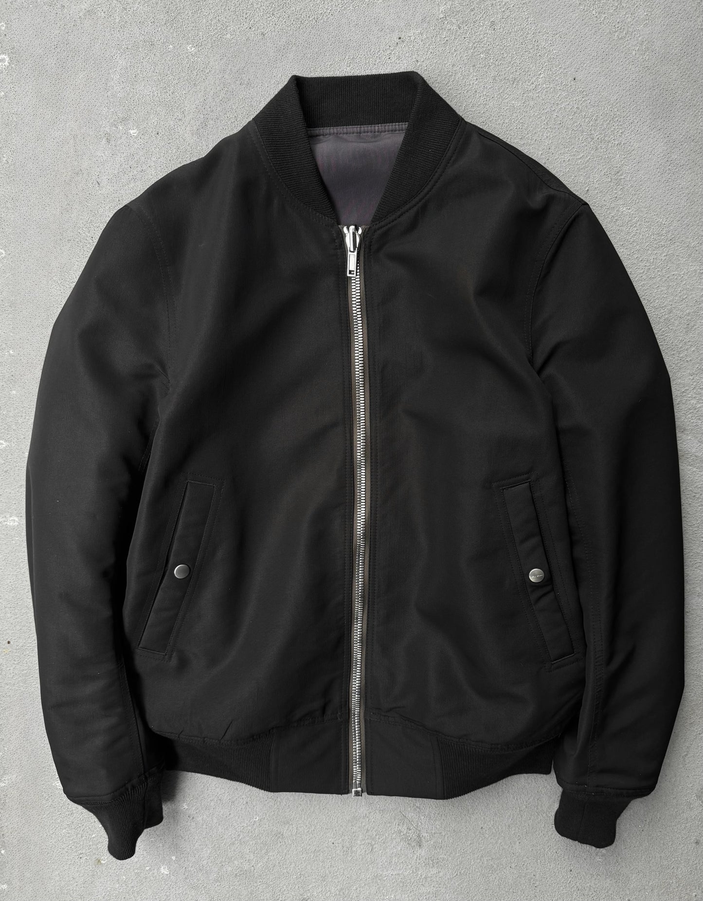 Black bomber jacket on a gray background
