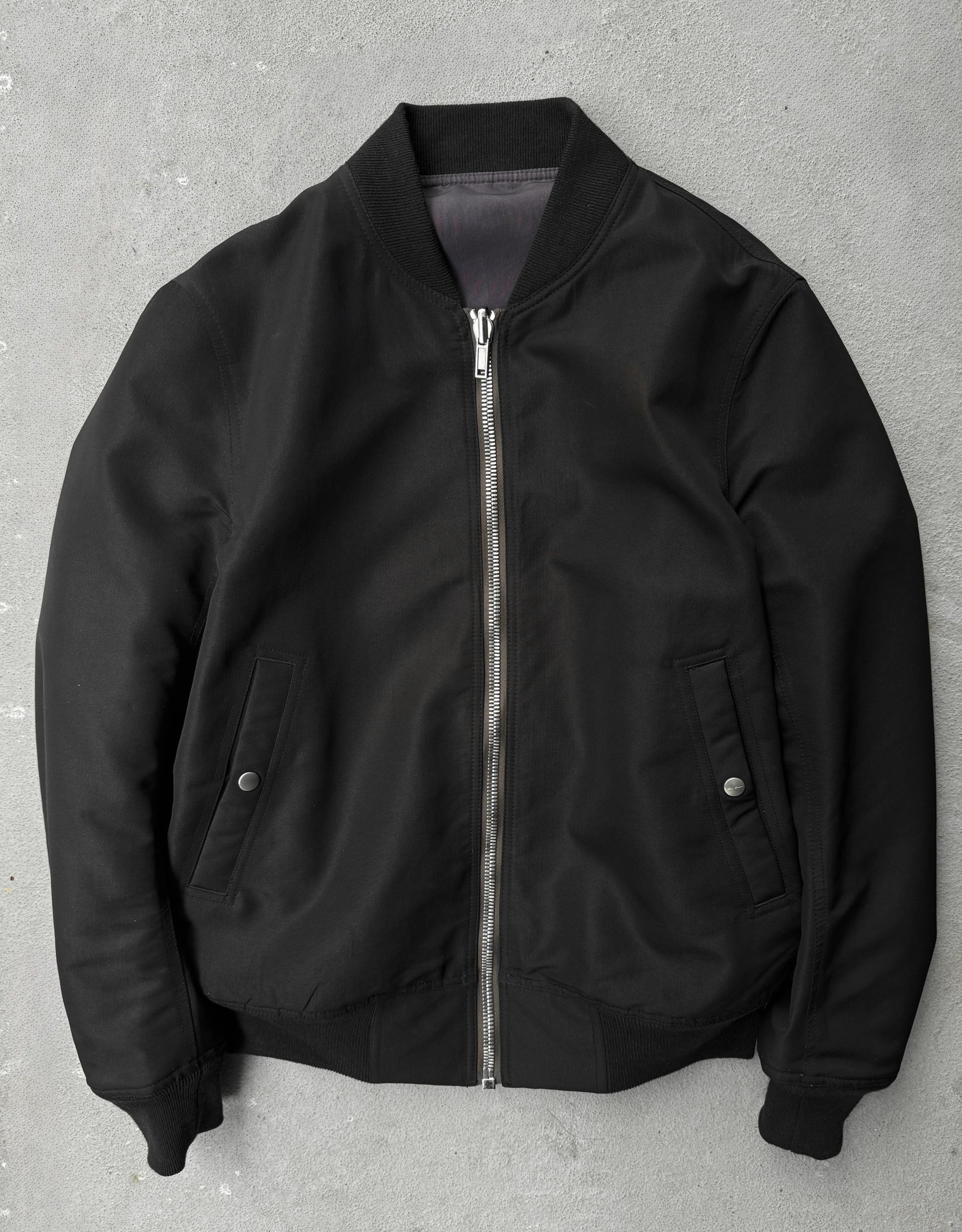 Black bomber jacket on a gray background