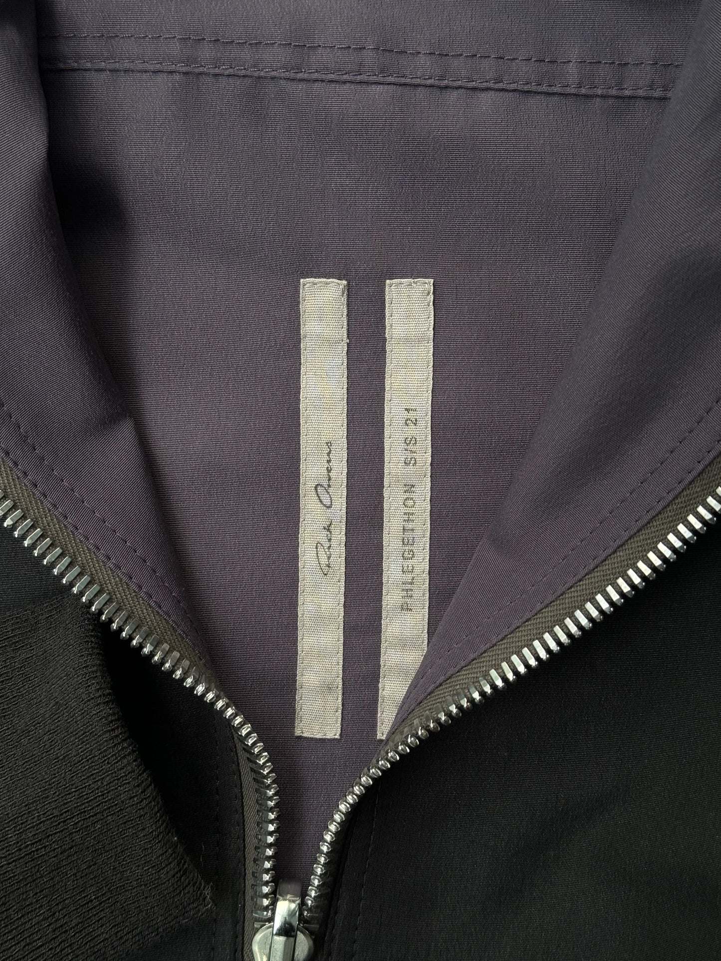 Close-up of a jacket with a brand logo on a dark background