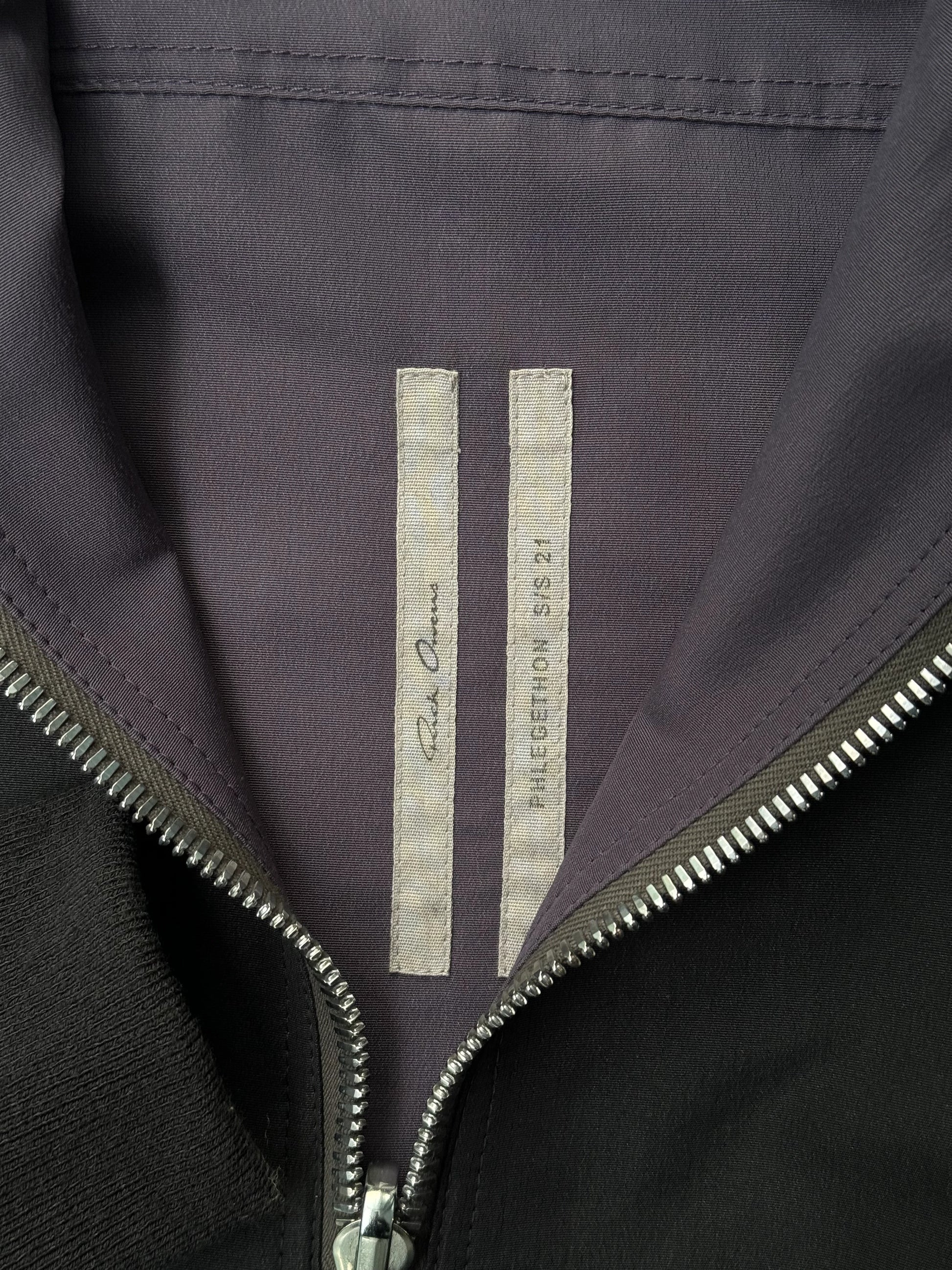 Close-up of a jacket with a brand logo on a dark background
