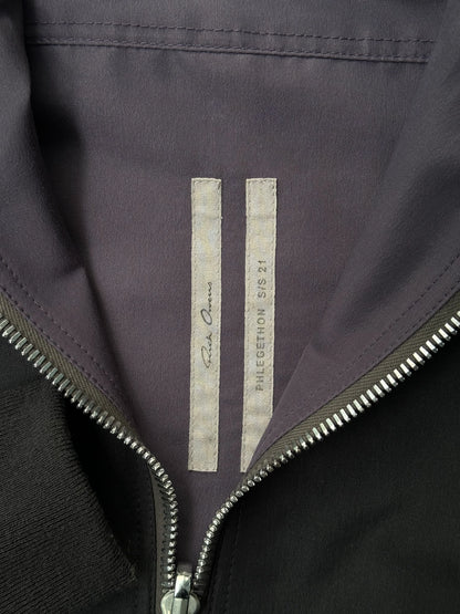 Close-up of a jacket with a brand logo on a dark background