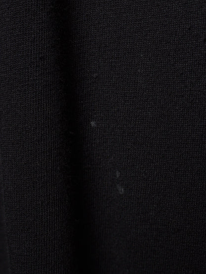 Close-up of a black ribbed knit fabric texture with a subtle sheen.