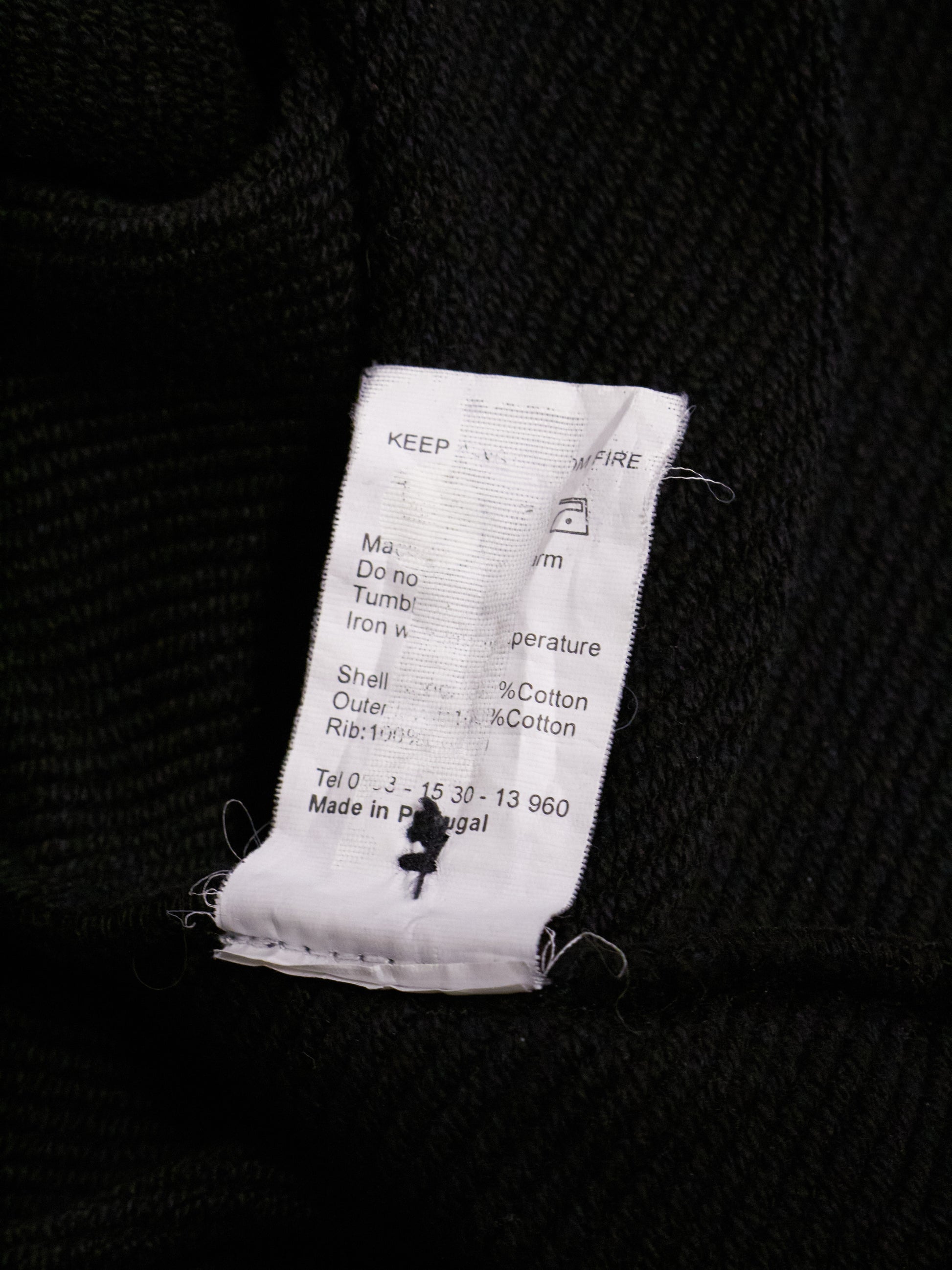 Textile label on a black fabric background