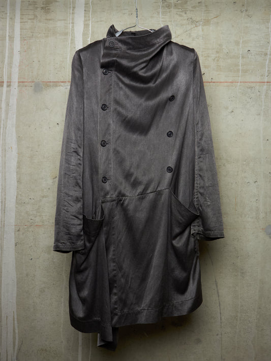 Gray coat hanging on a textured wall