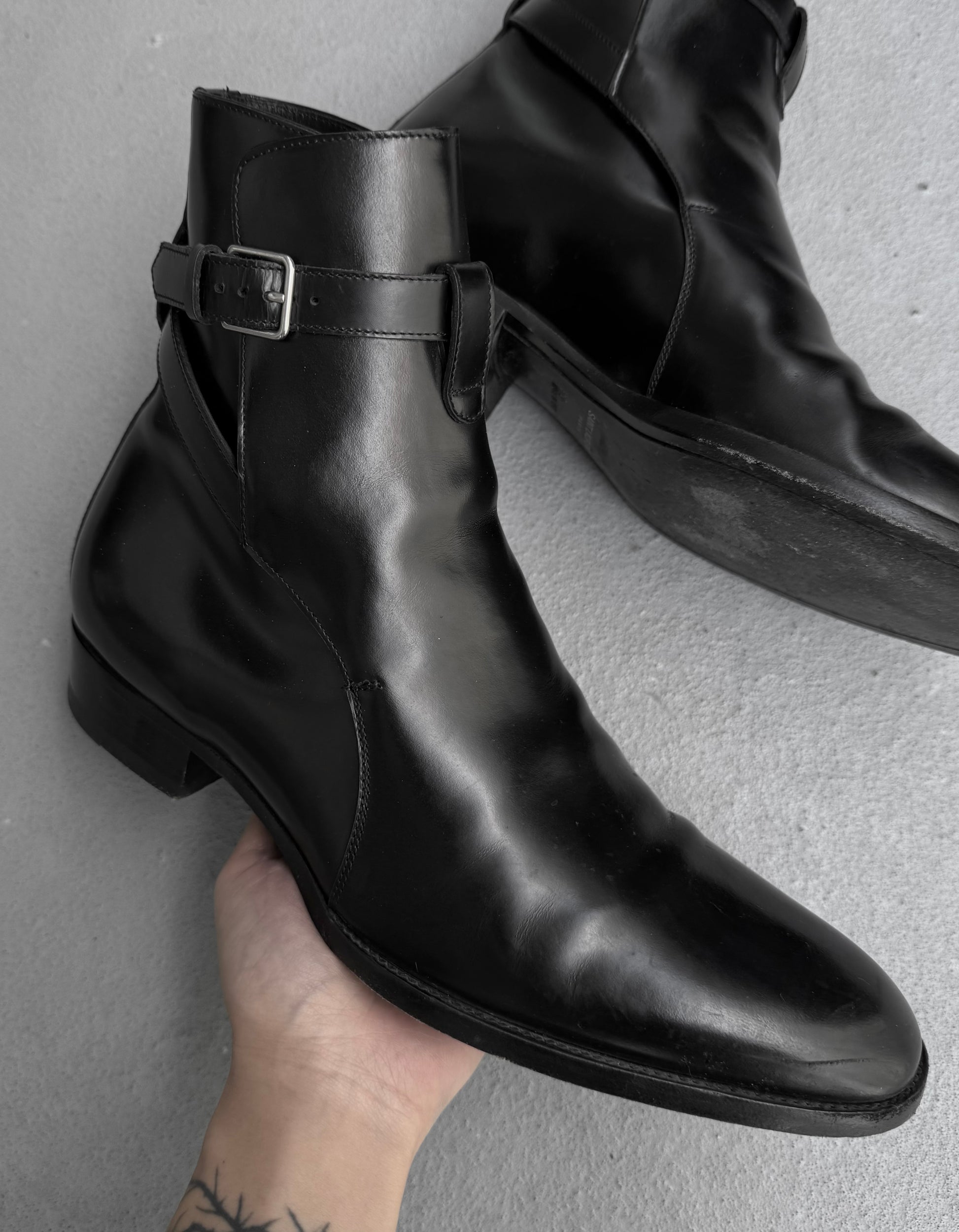 Black leather boot with a buckle