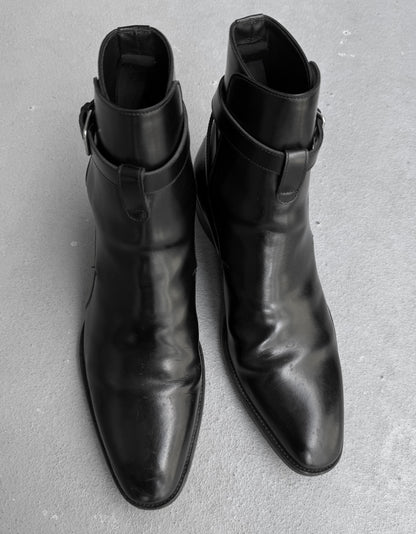 Pair of black leather ankle boots on a gray background
