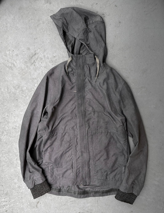 Dark gray hooded jacket on a textured gray surface