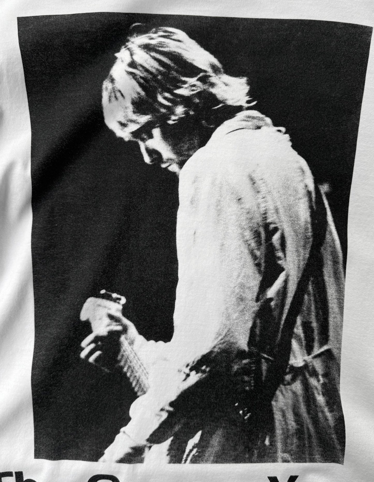 Black and white graphic of a person playing guitar on a white background