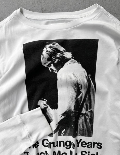 White sweatshirt with a graphic of a person and text 'The Grungy Years Taught Me to Smile' on a gray background