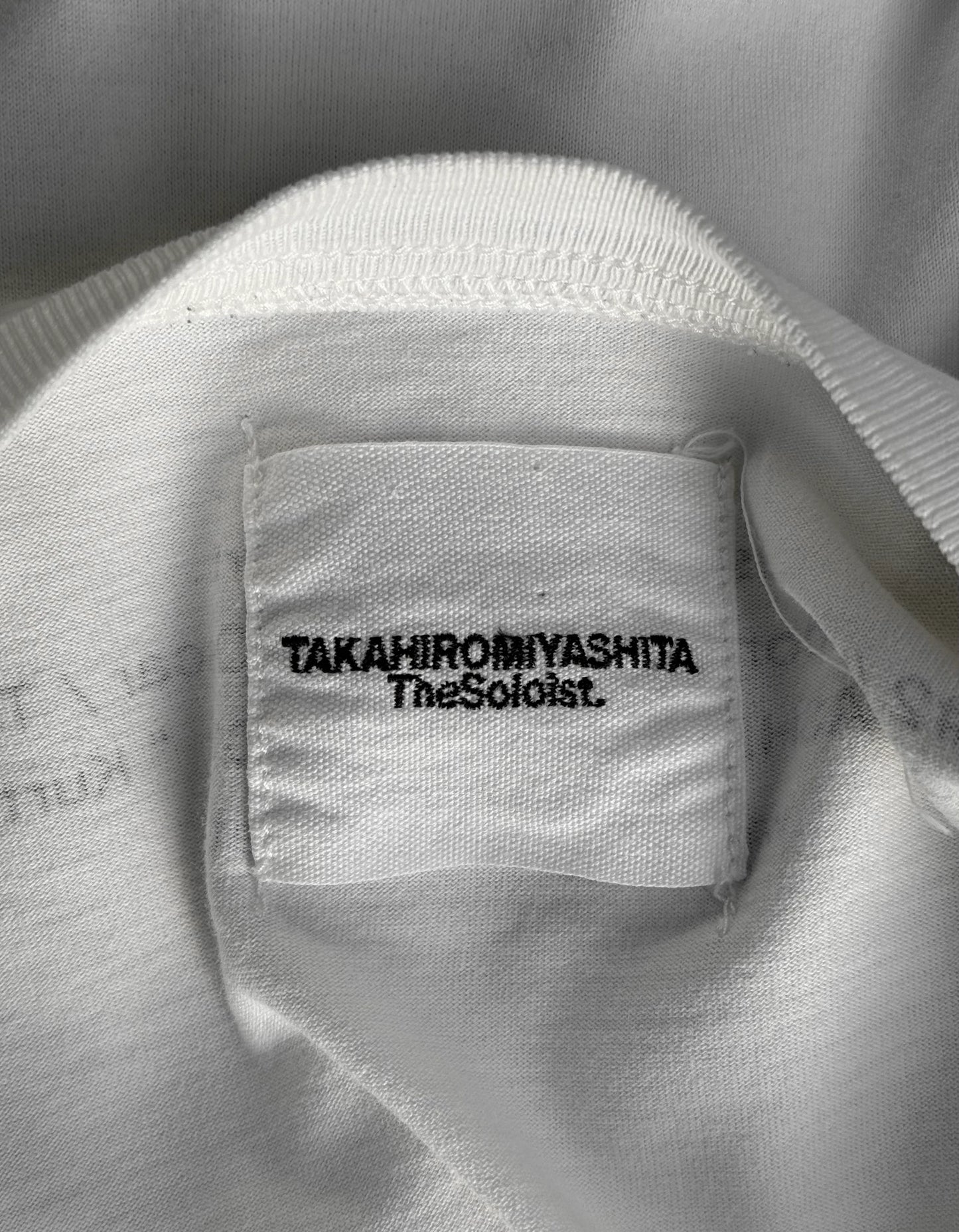 Close-up of a label on a white garment with text