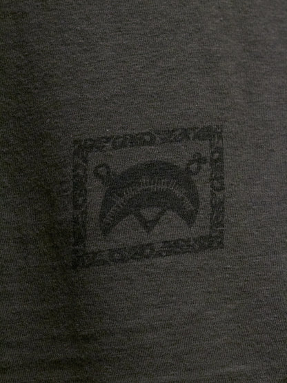 Close-up of a dark gray t-shirt with a logo on the chest.