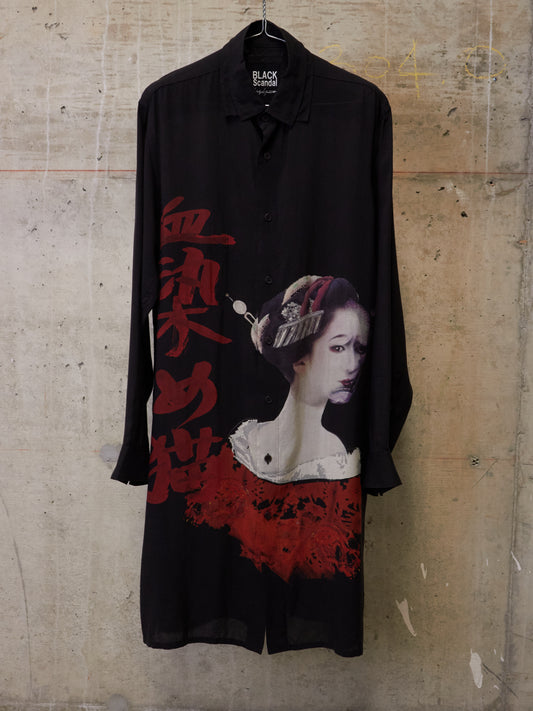 Black shirt with a graphic design of a woman's face and red text on a textured wall background