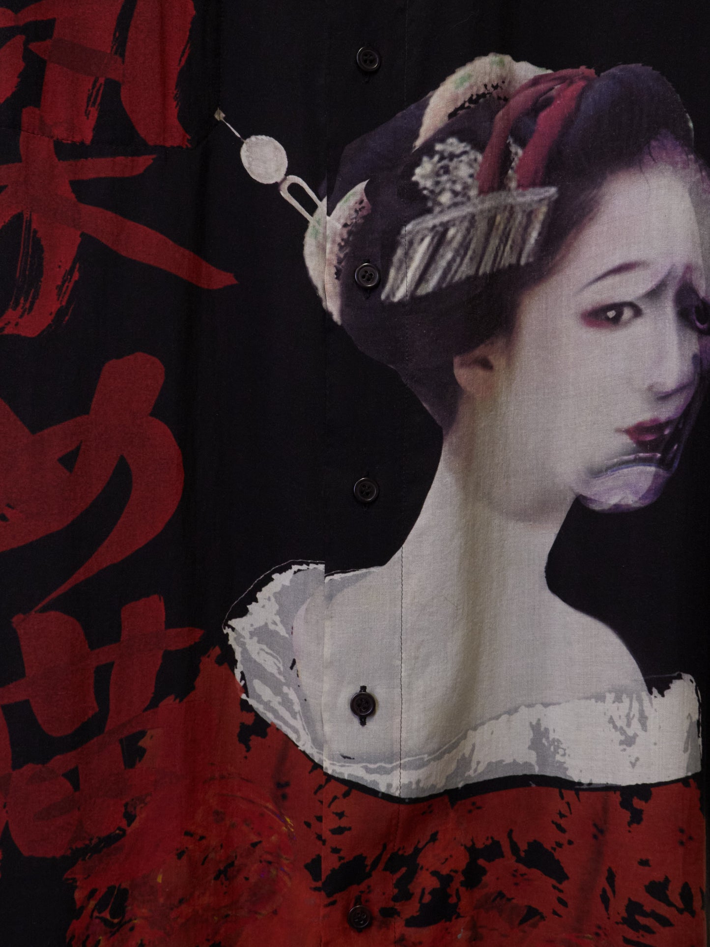 Traditional Japanese geisha design on a black background with red text