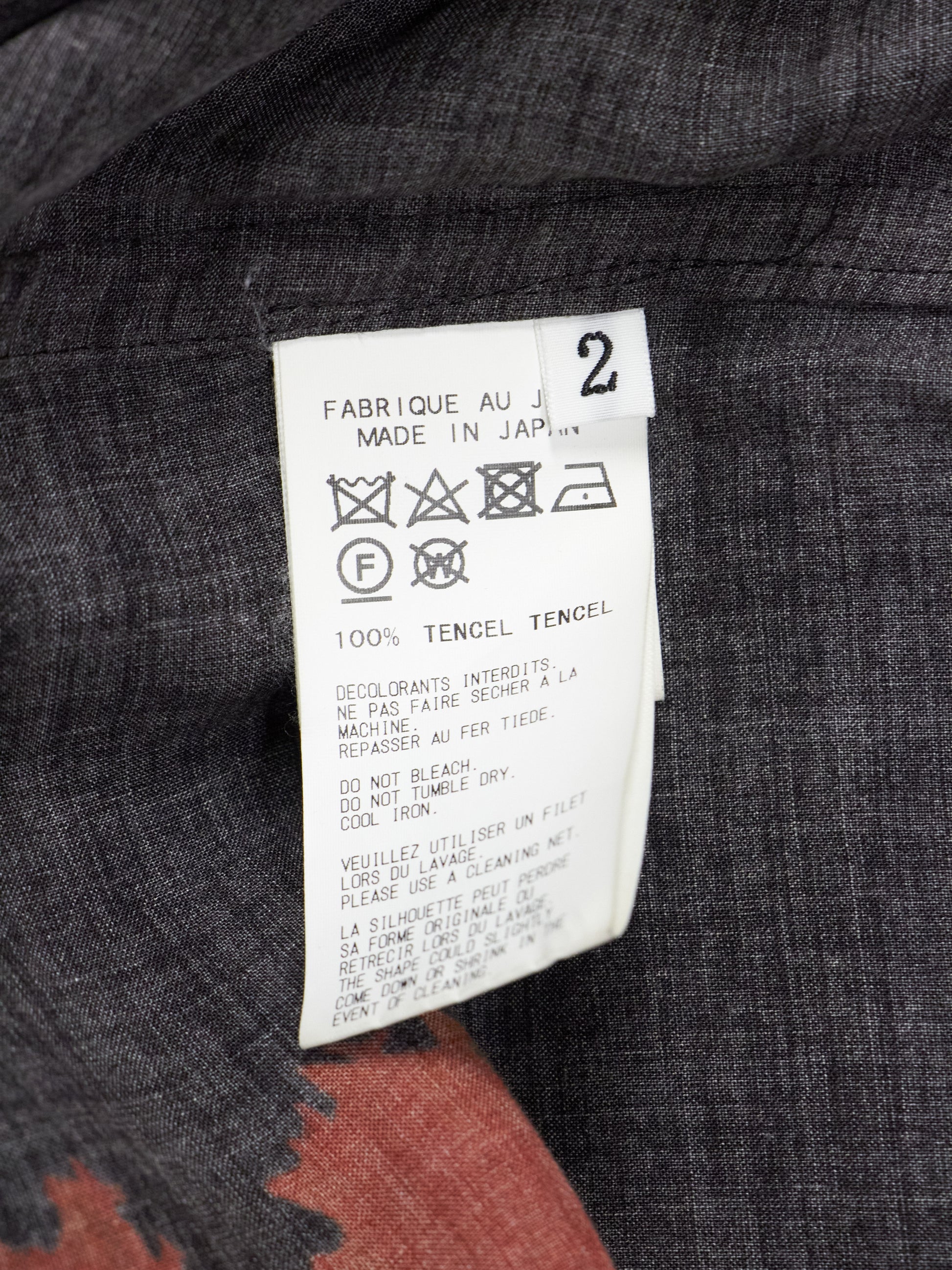 Fabric tag on a garment with text and symbols