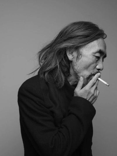 Yohji Yamamoto portrait in black and white — avant-garde clothing designer known for drapey and moody designs