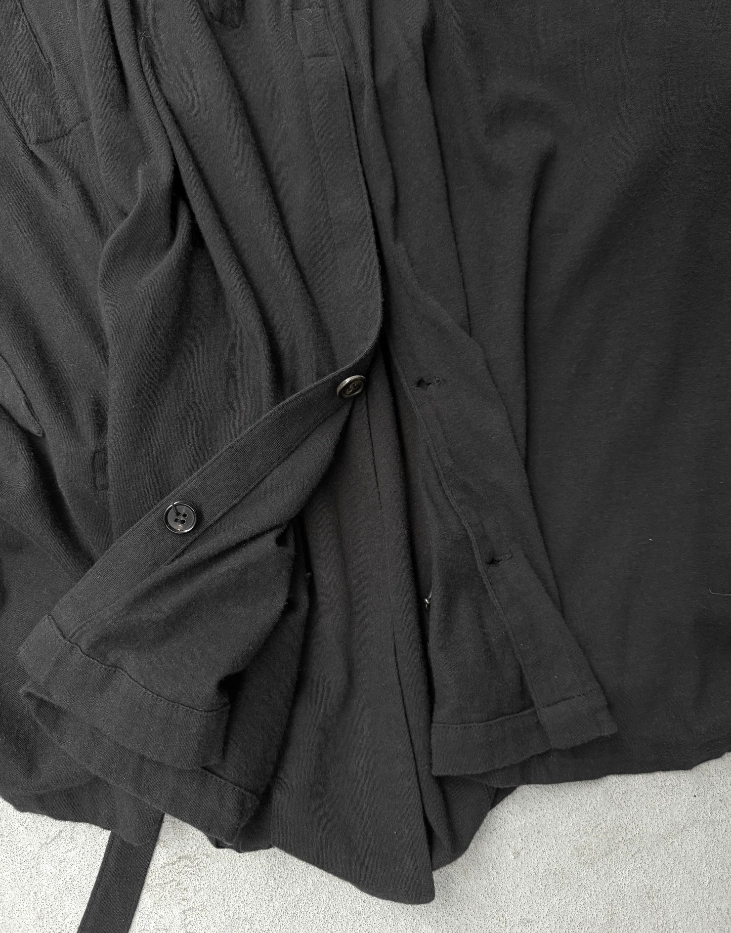 Black coat draped over a surface