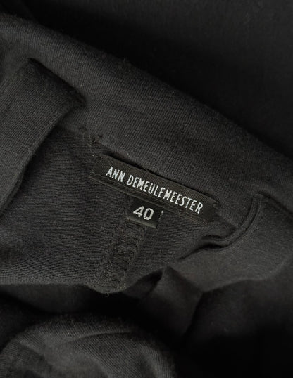 Black clothing with Ann Demeulemeester label and size 40 on a dark background
