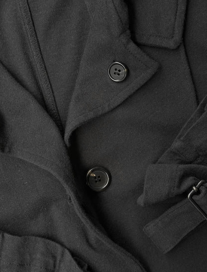 Close-up of a dark gray coat with buttons and a belt.