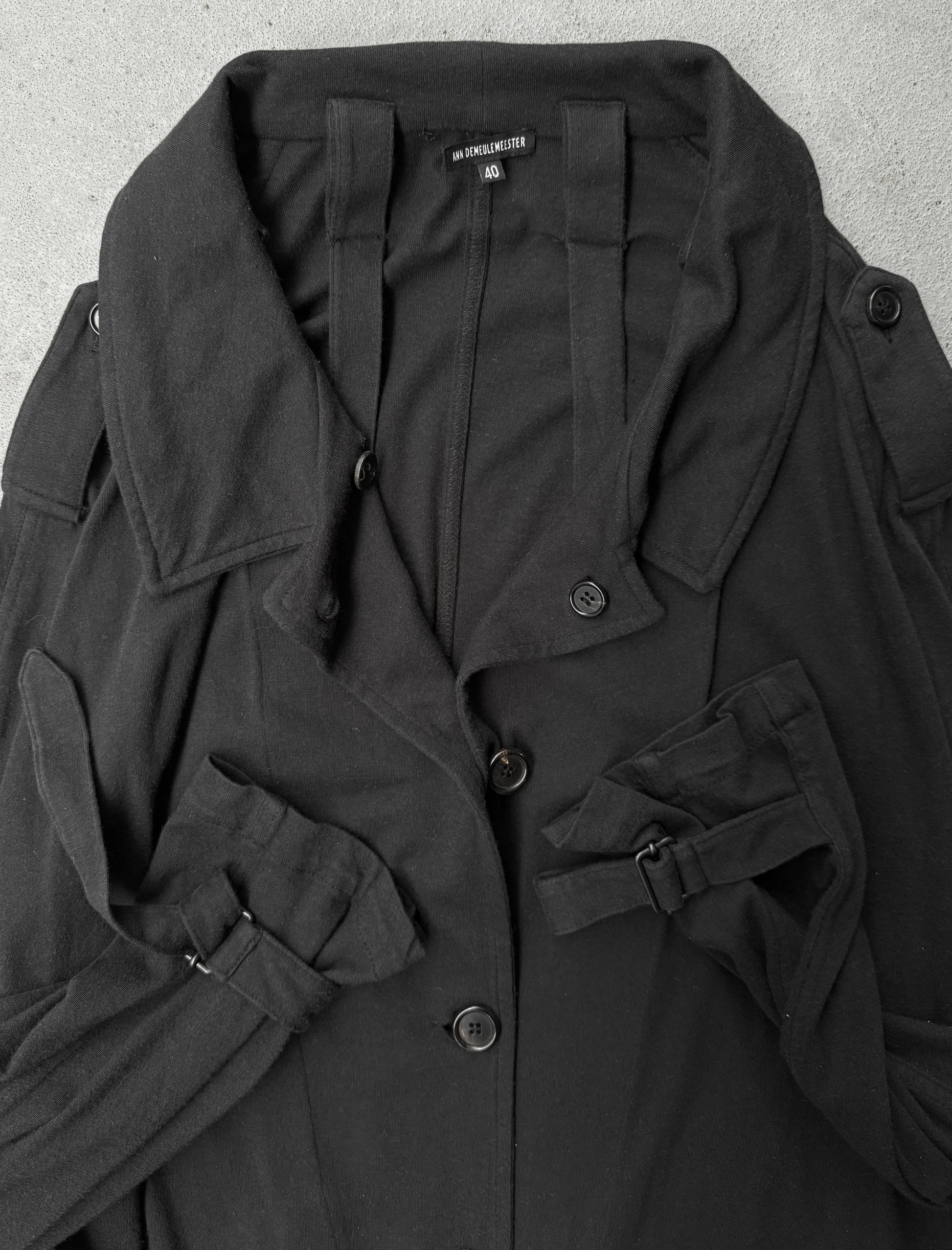 Black coat with button details on a light gray background