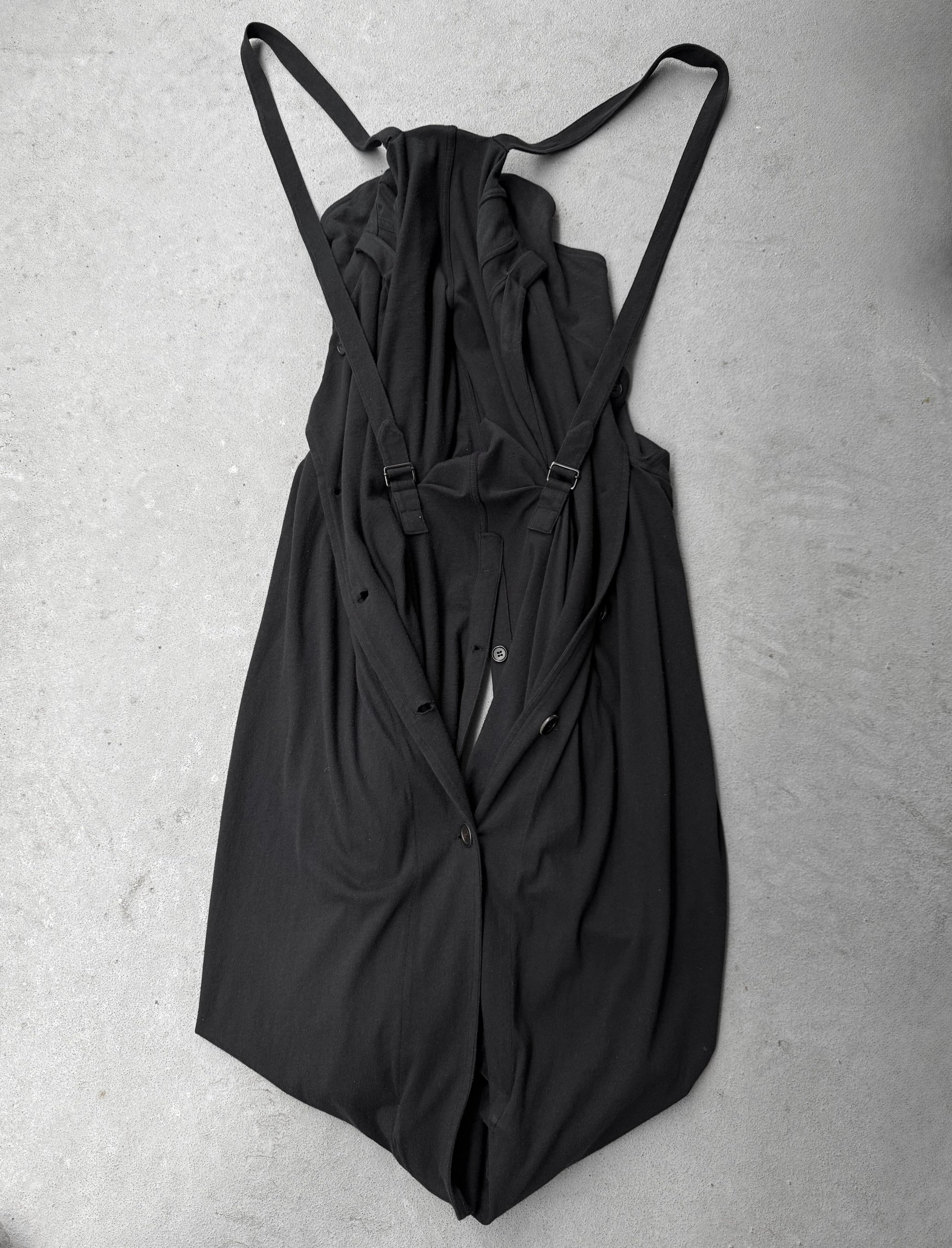 Black dress with thin straps on a gray surface