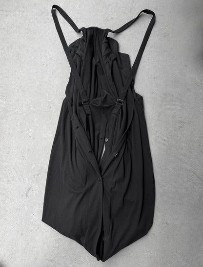 Black dress with thin straps on a gray surface