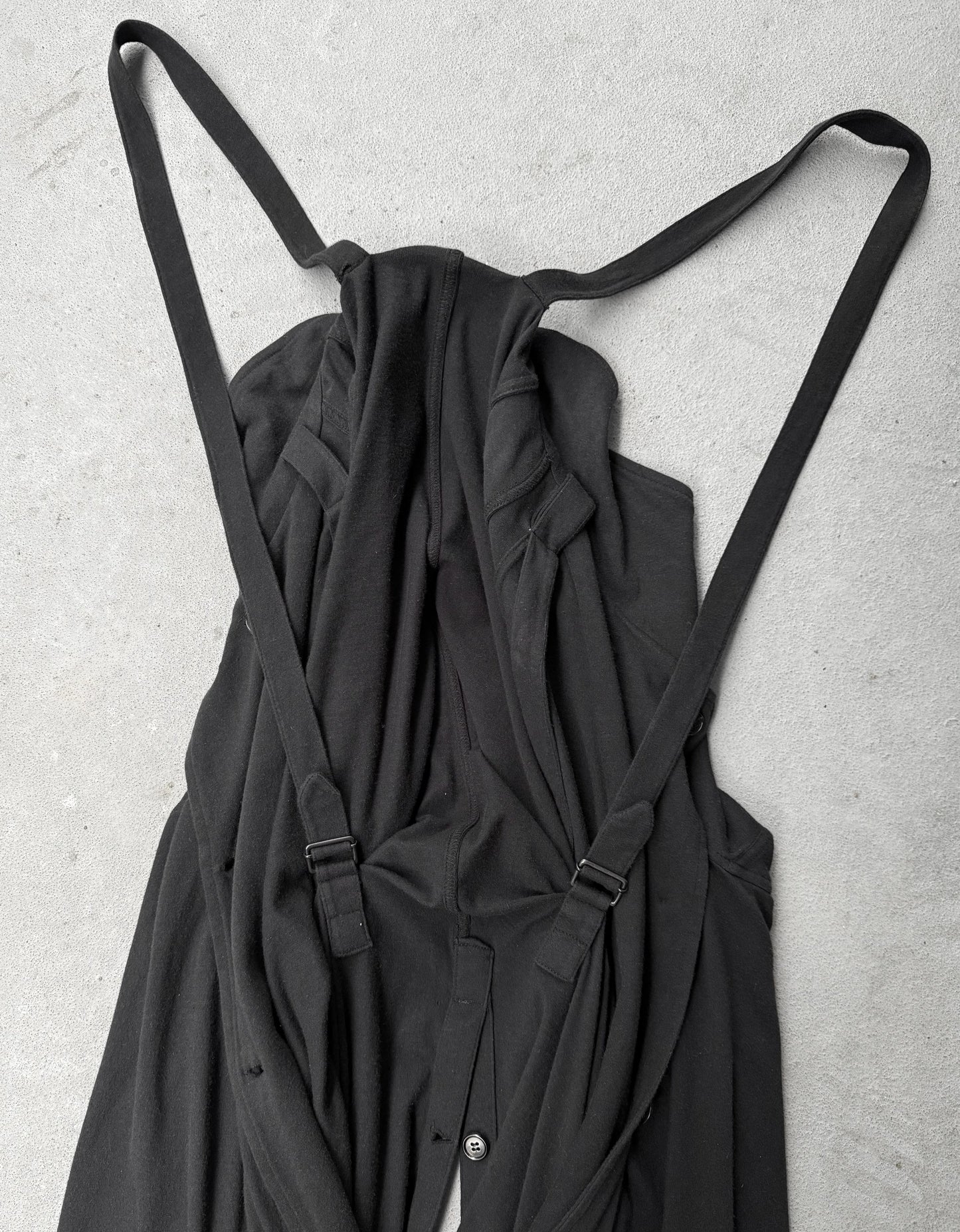 Black dress with straps on a light gray background