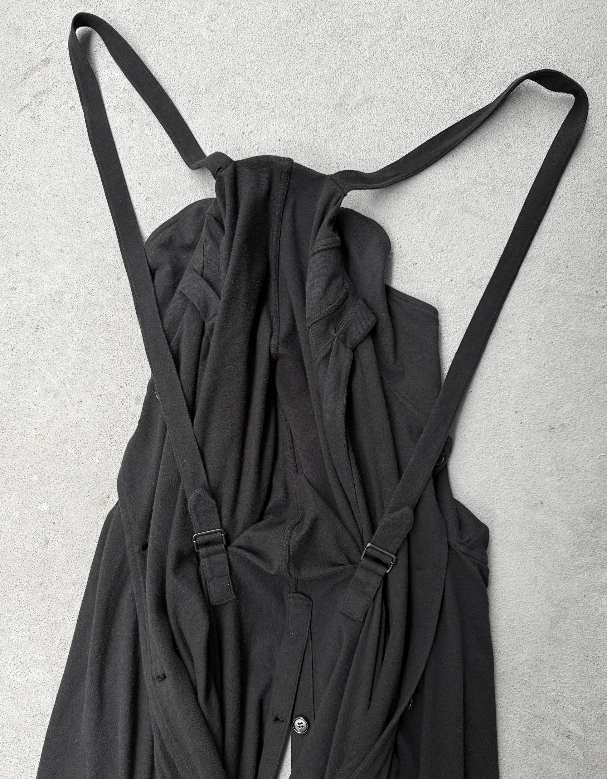 Black dress with straps on a light gray background