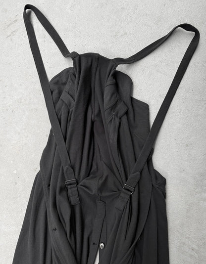 Black dress with straps on a light gray background