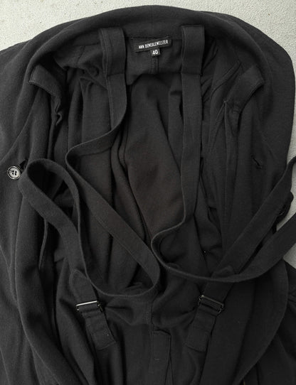 Black jacket with straps on a light gray background