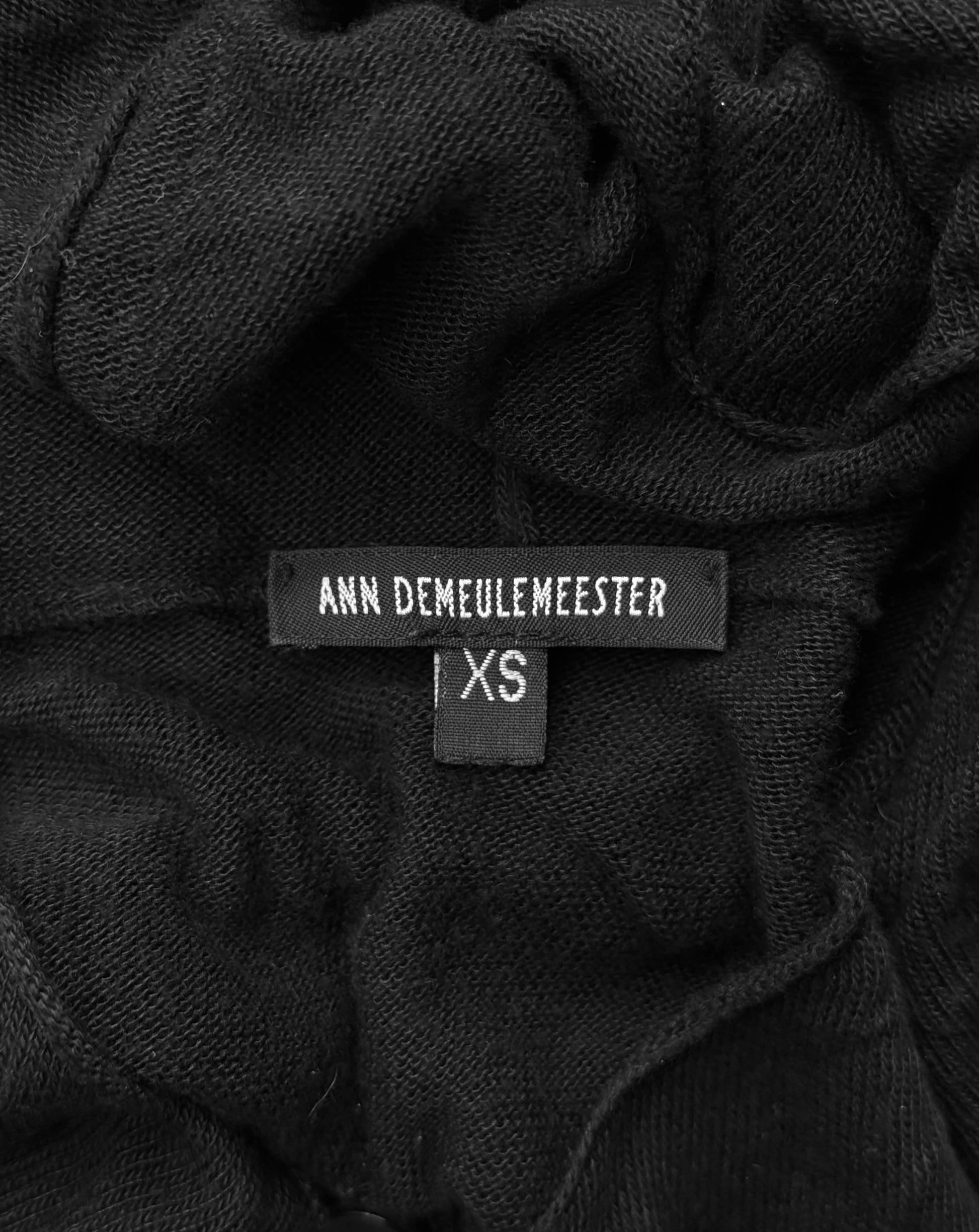 Close-up of a black garment with 'Ann Demeulemeester' label and size tag.
