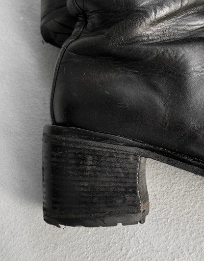 Close-up of a black leather boot sole on a light gray background