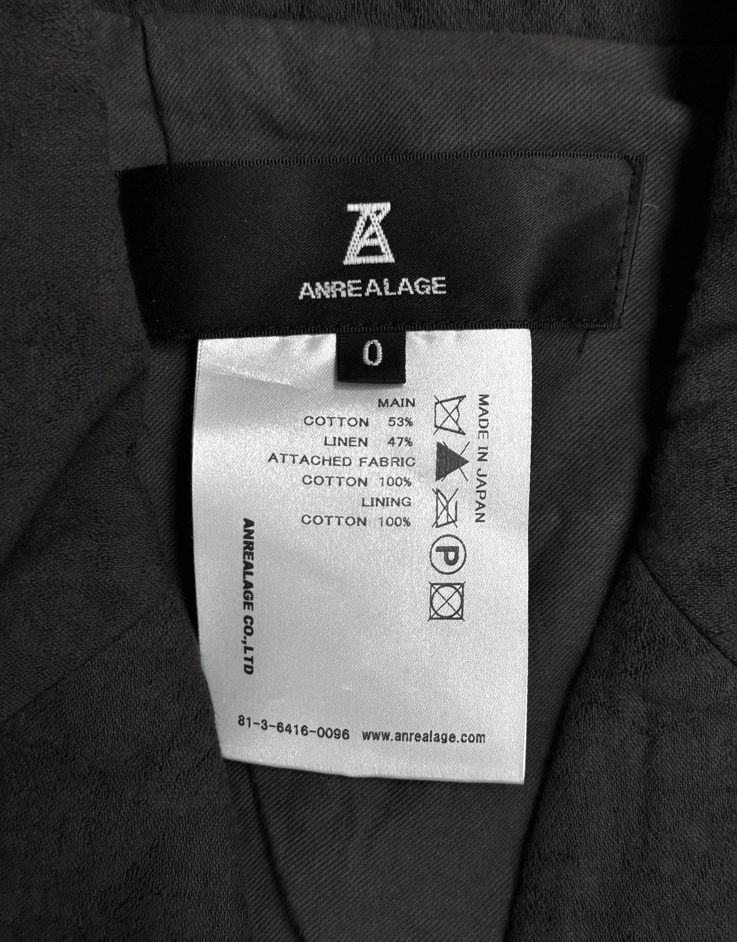 Label on a garment with 'Anrealage' branding and text details.