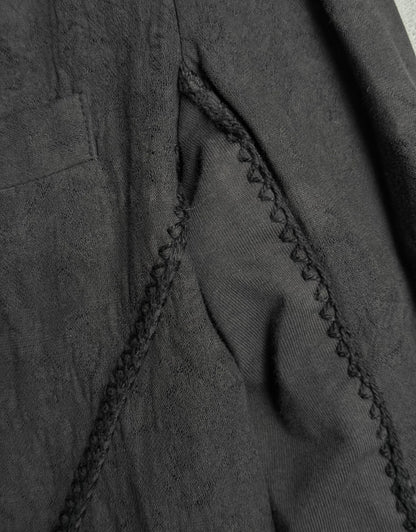 Close-up of a dark gray fabric with stitching detail