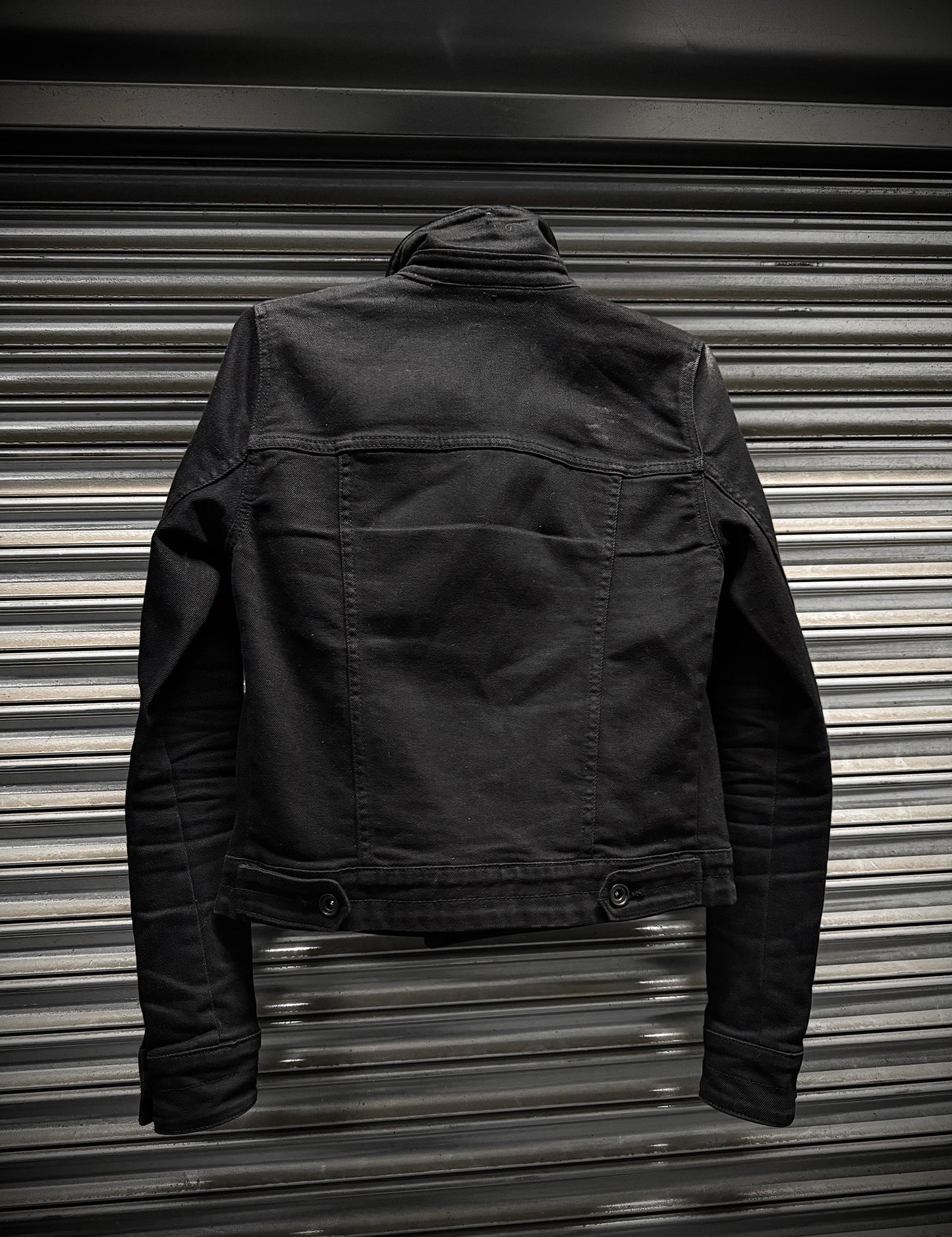 Black jacket on a metallic surface