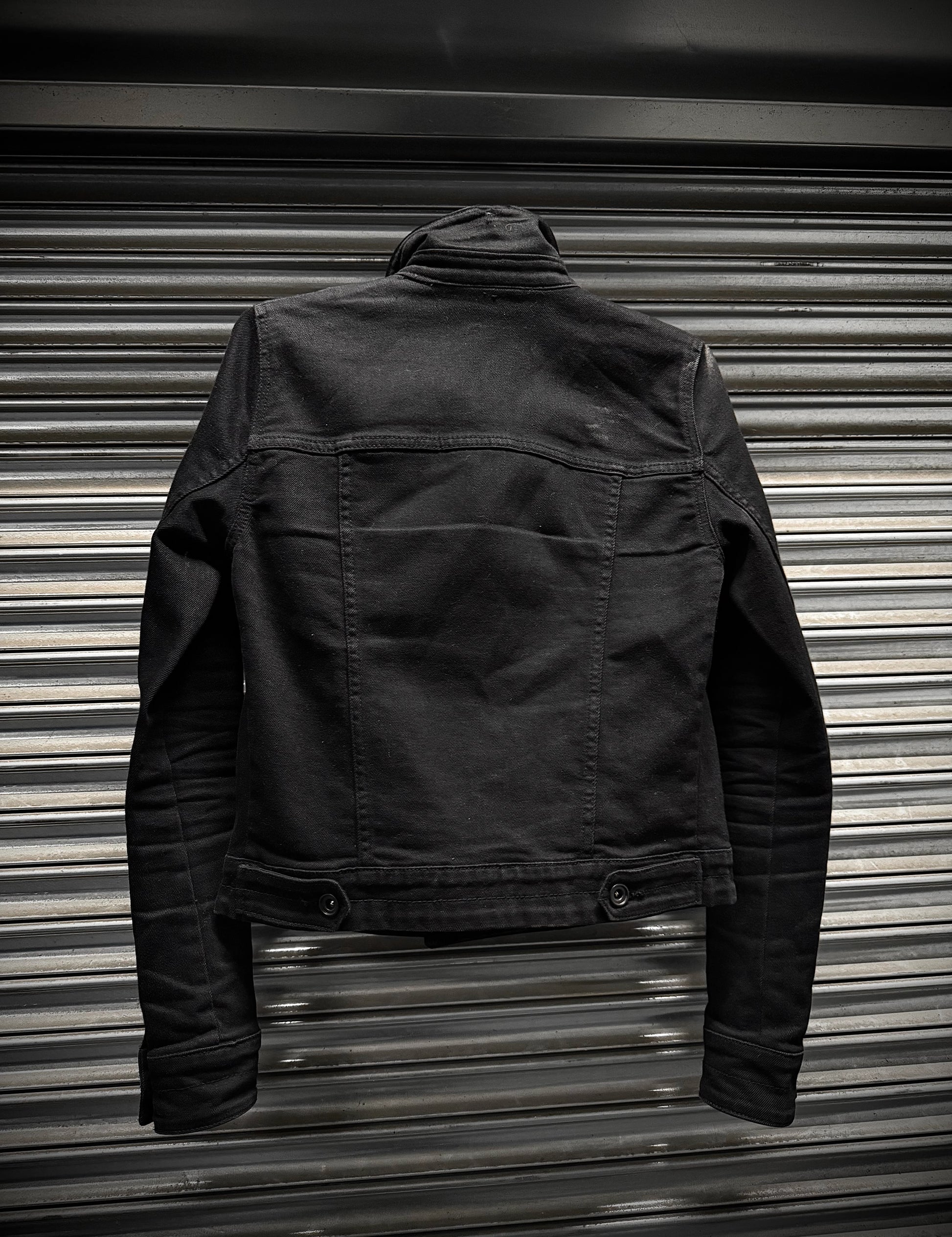 Black jacket on a metallic surface