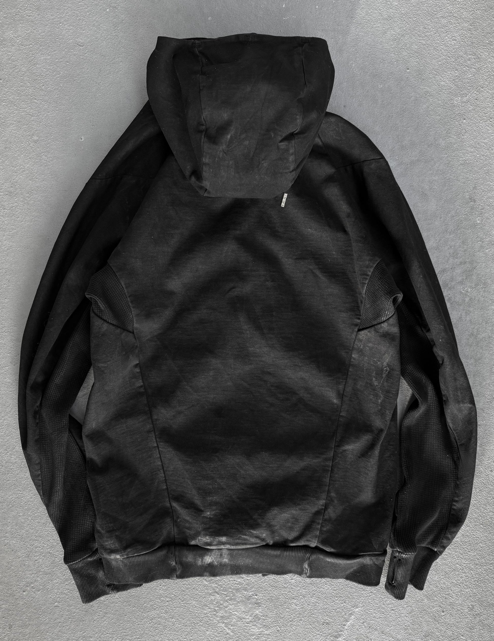 Black hooded jacket on a gray background