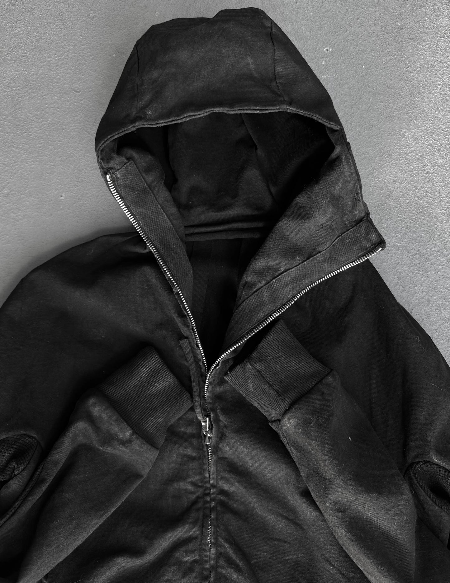 Black hooded jacket on a gray background